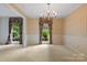 Traditional dining room featuring striped wallpaper, a vintage chandelier, and two bright windows at 1940 12Th Ne St, Hickory, NC 28601