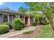 Close-up of charming brick home highlighting the front entrance, manicured shrubs, and walkway at 1940 12Th Ne St, Hickory, NC 28601