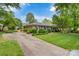 Inviting one-story brick home featuring a long driveway and well-manicured lawn and shrubbery at 1940 12Th Ne St, Hickory, NC 28601