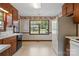 Bright eat-in kitchen area features white refrigerator, wood cabinets, and a large window at 1940 12Th Ne St, Hickory, NC 28601