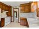 Vintage-style kitchen showcasing wooden cabinets and white appliances next to doorways to other rooms at 1940 12Th Ne St, Hickory, NC 28601