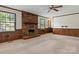 Traditional living room featuring a brick fireplace, wood paneling, and large windows at 1940 12Th Ne St, Hickory, NC 28601