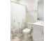 Well-lit bathroom featuring a toilet, vanity with sink, and a shower featuring a botanical-themed curtain at 2019 Tears Ln, Charlotte, NC 28217