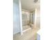 Tiled shower with a built-in bench, glass door and chrome fixtures at 2019 Tears Ln, Charlotte, NC 28217