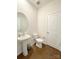 Bathroom featuring a pedestal sink, hardwood floors, white walls, and modern fixtures at 2019 Tears Ln, Charlotte, NC 28217