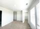 Neutral bedroom with plush carpet, white walls, and generous closet space at 2019 Tears Ln, Charlotte, NC 28217