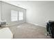 Bright bedroom with neutral carpet, white walls, and natural light at 2019 Tears Ln, Charlotte, NC 28217