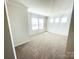 Spacious bedroom with plush carpeting, white walls, and large windows providing ample light at 2019 Tears Ln, Charlotte, NC 28217