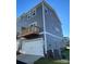 Townhome exterior featuring gray siding, white trim, attached garage, and a private balcony at 2019 Tears Ln, Charlotte, NC 28217