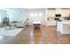 Open-concept living area with hardwood floors, white walls, and plenty of natural light at 2019 Tears Ln, Charlotte, NC 28217