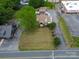 Aerial shot of a residential property with a well-manicured lawn, mature trees, and a paved driveway at 2036 1St Sw Ave, Hickory, NC 28602