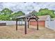 Fenced backyard featuring a wooden gazebo, brick accents, and a landscaped area for outdoor enjoyment at 2036 1St Sw Ave, Hickory, NC 28602
