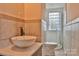 The bathroom features a vessel sink on a granite countertop and a tile shower with a glass block window at 2036 1St Sw Ave, Hickory, NC 28602