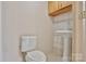 A half bath with a pedestal sink, a tiled backsplash, a cabinet, and a toilet at 2036 1St Sw Ave, Hickory, NC 28602