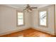 This bedroom offers hardwood floors, a ceiling fan, and natural light from the two windows at 2036 1St Sw Ave, Hickory, NC 28602