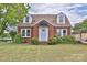 Charming two-story brick home featuring dormer windows, a covered entryway, and well-maintained landscaping at 2036 1St Sw Ave, Hickory, NC 28602