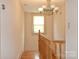 A staircase landing area with a wooden handrail and traditional style chandelier at 2036 1St Sw Ave, Hickory, NC 28602