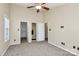 Spacious bedroom featuring carpet, a window, and multiple doors, offering versatility at 2045 Flushing Ct, Charlotte, NC 28215