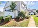 Townhouse with manicured bushes, a satellite dish, and a partial fence at 2045 Flushing Ct, Charlotte, NC 28215