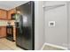 The compact kitchen area is adjacent to a laundry area and features wood cabinets at 2045 Flushing Ct, Charlotte, NC 28215