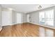 Bright living room with wood floors, three entry doors, and multiple windows for natural light at 2045 Flushing Ct, Charlotte, NC 28215