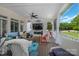 Inviting covered porch with cozy seating, a ceiling fan, and views of the outdoor space at 21216 Norman Shores Dr, Cornelius, NC 28031