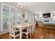 Bright dining area with hardwood floors and an open plan, leading to a cozy living space at 21216 Norman Shores Dr, Cornelius, NC 28031