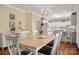 Bright dining area with hardwood floors and an open plan, leading to the kitchen at 21216 Norman Shores Dr, Cornelius, NC 28031