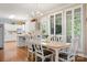 Bright dining area featuring hardwood floors, white trim, and views of the adjacent kitchen at 21216 Norman Shores Dr, Cornelius, NC 28031