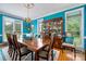 Elegant dining room featuring bright blue walls, a wooden table, and a vintage chandelier at 21216 Norman Shores Dr, Cornelius, NC 28031