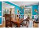 Stylish dining room with a large wooden table, bright blue walls, and an open view to the living room at 21216 Norman Shores Dr, Cornelius, NC 28031