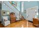 Inviting foyer with a staircase, light blue walls, hardwood floors, and decorative furnishings at 21216 Norman Shores Dr, Cornelius, NC 28031