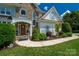 Close-up of the front entrance with a stone walkway and manicured landscaping around the entryway at 21216 Norman Shores Dr, Cornelius, NC 28031