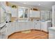Bright kitchen with white cabinets, hardwood floors, and a window providing natural light at 21216 Norman Shores Dr, Cornelius, NC 28031