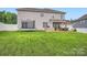 Wide shot of a backyard, including lawn, patio with bar, grill, and an adjacent trampoline at 2322 Tessa Trce, Clover, SC 29710