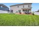 Large, green backyard featuring a well-maintained lawn, patio, bar area, and recreational trampoline at 2322 Tessa Trce, Clover, SC 29710
