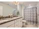 Bathroom with double sink vanity, granite counters, shower with decorative curtain, and tile floor at 2322 Tessa Trce, Clover, SC 29710