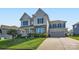 Charming two-story home featuring stone accents, gray siding, and a well-manicured lawn with a concrete driveway at 2322 Tessa Trce, Clover, SC 29710