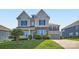 Charming two-story home featuring stone accents, gray siding, and a well-manicured lawn with a concrete driveway at 2322 Tessa Trce, Clover, SC 29710