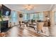 Bright living room with a fireplace, large windows, and hardwood floors with a stylish rug at 2322 Tessa Trce, Clover, SC 29710
