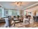 Open-concept living room featuring a comfortable sectional sofa, area rug, and hardwood flooring at 2322 Tessa Trce, Clover, SC 29710
