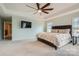 A spacious main bedroom featuring a tray ceiling, neutral wall paint, and a ceiling fan at 2322 Tessa Trce, Clover, SC 29710