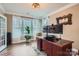 Well-lit home office with a large desk, hardwood floors, and a view of the outdoors at 2322 Tessa Trce, Clover, SC 29710