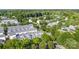 An aerial view shows a community of townhouses surrounded by mature trees and green spaces at 239 N Faulkner Way, Davidson, NC 28036