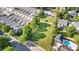 An aerial view shows a community with townhomes, a community green space, and a swimming pool at 239 N Faulkner Way, Davidson, NC 28036