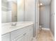 Neutral bathroom featuring a well-lit vanity with storage, large mirror, and tiled floor at 239 N Faulkner Way, Davidson, NC 28036