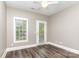 Bedroom with hardwood floors, a ceiling fan, neutral paint, and access to backyard at 239 N Faulkner Way, Davidson, NC 28036