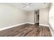 Bedroom features hardwood floors, neutral walls, ceiling fan, and closet space at 239 N Faulkner Way, Davidson, NC 28036