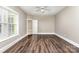 Bedroom featuring hardwood floors, a ceiling fan, neutral paint, and a walk-in closet at 239 N Faulkner Way, Davidson, NC 28036