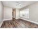 Bedroom features hardwood floors, neutral walls, a ceiling fan, and natural light at 239 N Faulkner Way, Davidson, NC 28036